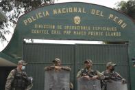 Police stand guard at the National Police base where former President Pedro Castillo is held after his arrest, facing charges of rebellion, on the outskirts of Lima, Peru, Thursday, Dec. 8, 2022. Peru's Congress voted to remove Castillo from office Wednesday and replace him with the vice president, shortly after Castillo tried to dissolve the legislature ahead of a scheduled vote to remove him. (AP Photo/Guadalupe Pardo)