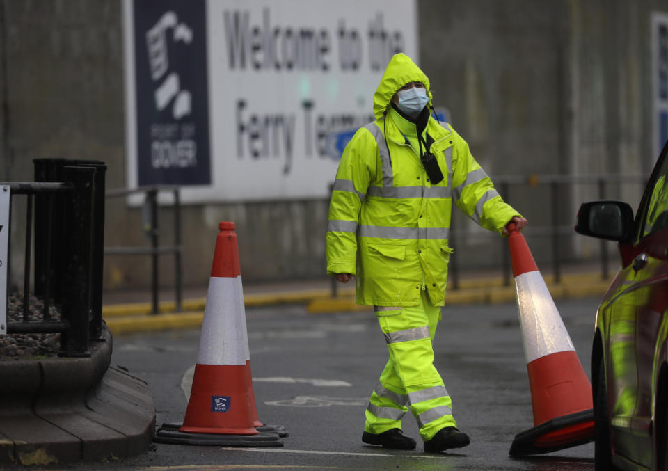 Security guard the entrance to the ferry terminal in Dover, England, Monday, Dec. 21, 2020, after the Port of Dover was closed and access to the Eurotunnel terminal suspended following the French government's announcement. France banned all travel from the UK for 48 hours from midnight Sunday, including trucks carrying freight through the tunnel under the English Channel or from the port of Dover on England's south coast. (AP Photo/Kirsty Wigglesworth)