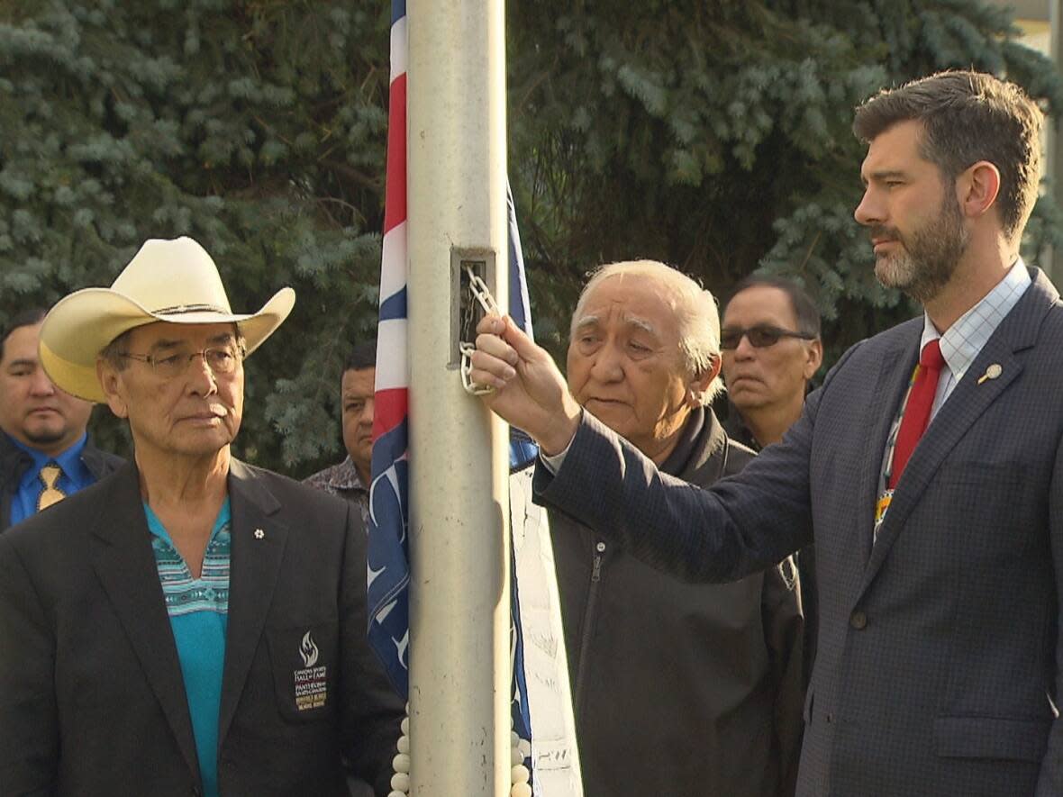 Wilton Littlechild, Grand Chief of Treaty No. 6, and Mayor Don Iveson prepare to raise the Treaty 6 flag outside city hall on Treaty No. 6 Recognition Day in 2019. (Nathan Gross/CBC - image credit)