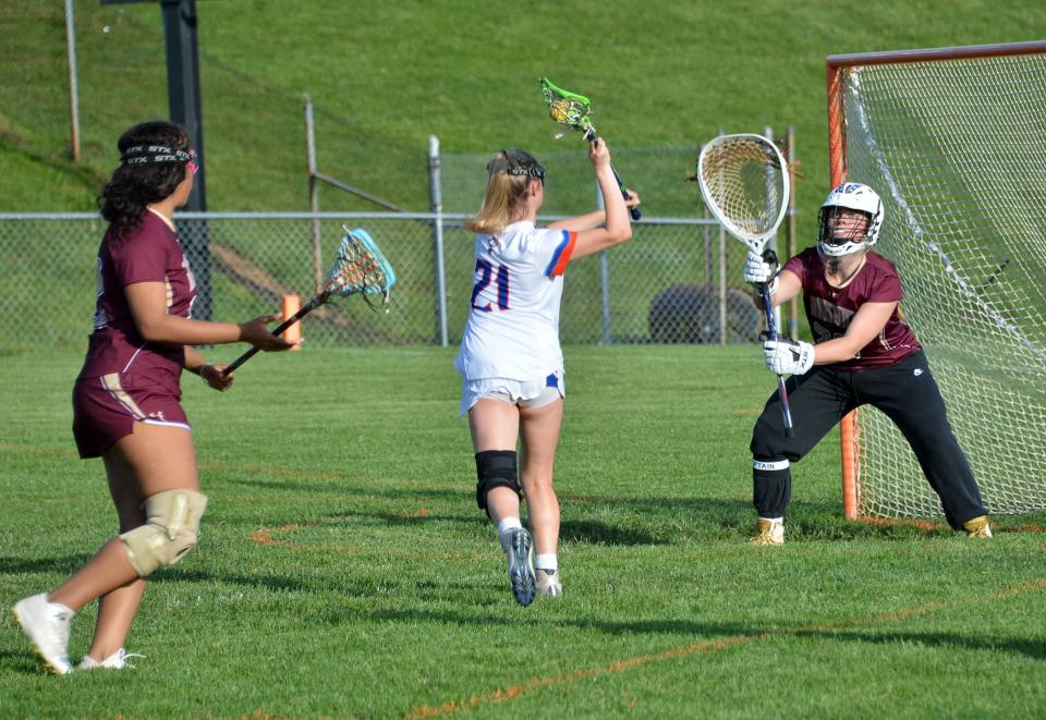Boonsboro's Taeler Stouffer (21) moves in on goal and scores one of her game-high five goals against Brunswick during the 1A West Region II girls lacrosse semifinal on May 13. The Warriors prevailed 23-1 and will host Smithsburg in the region final Monday.