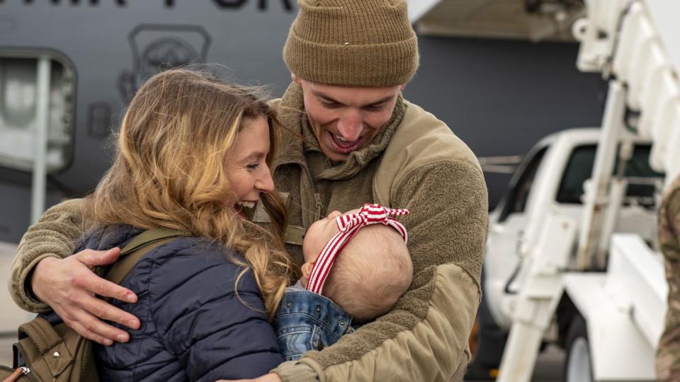 Staff Sgt. Caymen Bryant, assigned to the 121st Air Refueling Wing, is welcomed home by his family after returning from an overseas deployment at Rickenbacker Air National Guard Base, Ohio, Feb. 2, 2024. (Tech. Sgt. Wendy Kuhn/Air National Guard)