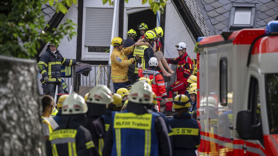 A person is rescued from the partially collapsed hotel in Kröv, Germany, on Wednesday. - Harald Tittel/dpa/AP