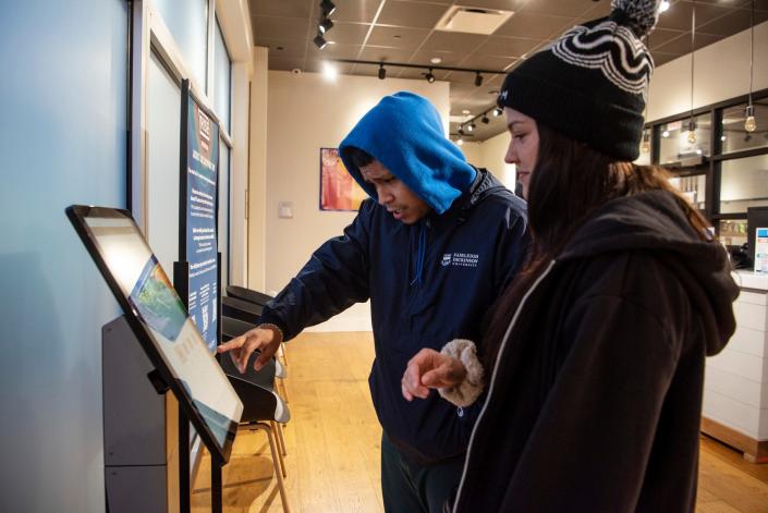 RISE in Paterson, opens for recreational marijuana sales at 6 a.m. on April 21, 2022, the first day recreational sales are allowed in New Jersey. Daniel Garcia, 23, of Union City, the first recreational customer at Rise, receives assistance from a Rise staff member while placing his order.