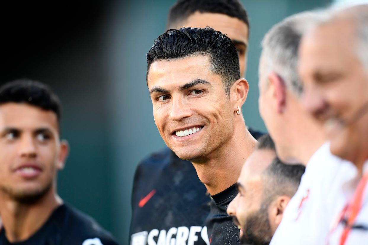 Portugal's Cristiano Ronaldo smiles by the bench before the UEFA Nations League soccer match between Spain and Portugal, at the Benito Villamarin Stadium, in Seville, Spain, Thursday, June 2, 2022. 