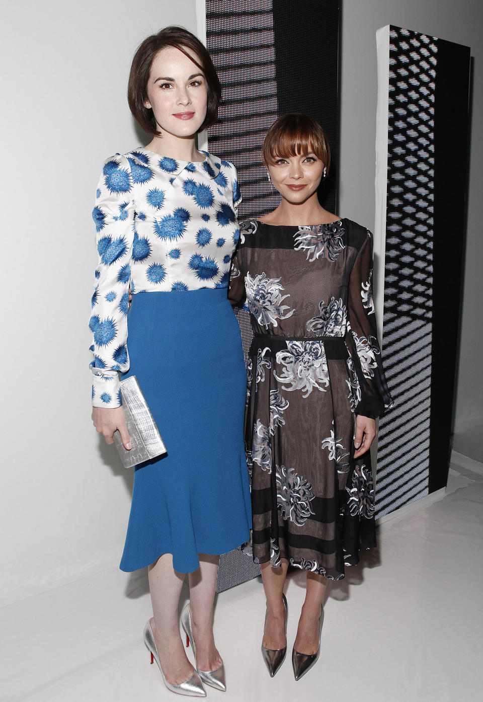 Michelle Dockery, left, and Christina Ricci attend the Carolina Herrera Spring 2014 collection on Monday, Sept. 9, 2013, during Mercedes-Benz Fashion Week in New York. (Photo by Amy Sussman/Invision/AP)