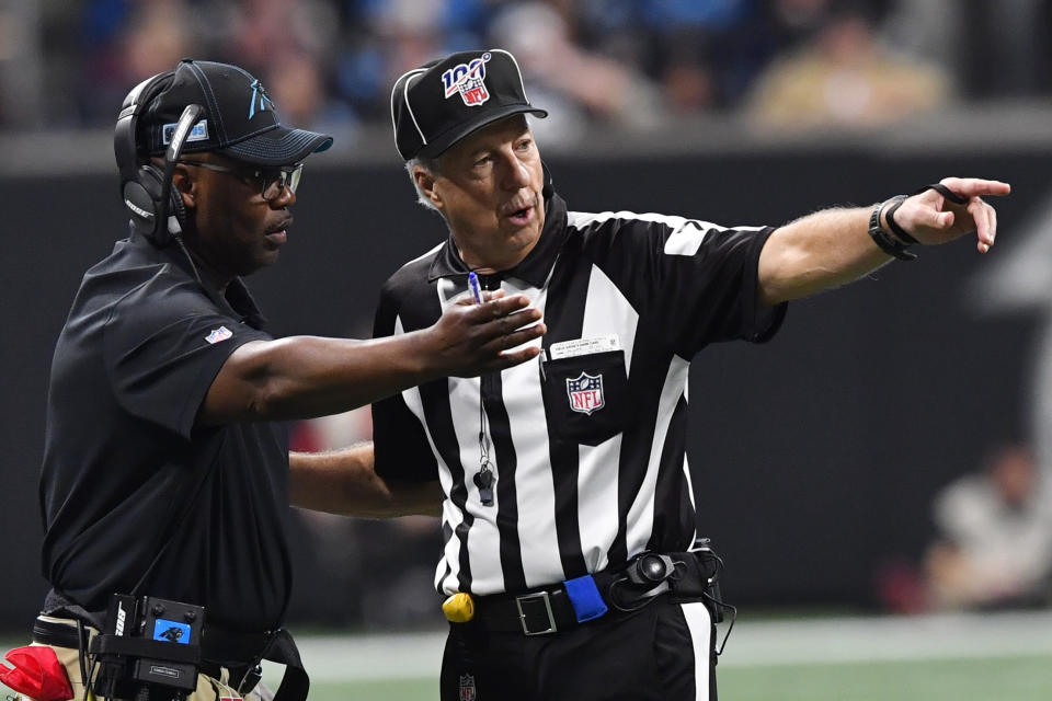 Carolina Panthers interim head coach Perry Fewell speaks with an offical during the second half of an NFL football game against the Atlanta Falcons, Sunday, Dec. 8, 2019, in Atlanta. (AP Photo/John Amis)