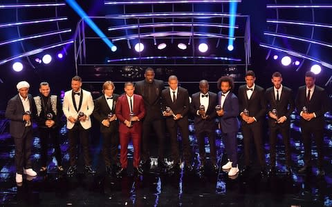 Former Brazil and Barcelona player Ronaldinho, Brazil and PSG defender Dani Alves, Real madrid and Spain defender Sergio Ramos, Real Madrid and Croatia midfielder Luka Modric, Chelsea and Belgium midfielder Eden Hazard, British actor and event host Idris Elba, Paris Saint-Germain and France forward Kylian Mbappe and Chelsea and France midfielder NGolo Kante, Brazil's defender Marcelo, France and real Madrid defender Raphael Varane, Manchester United and Spain goalkeeper David De Gea and presenter former Germany captain Michael Ballack with their trophies - Credit: Ben Stansall/Getty Images