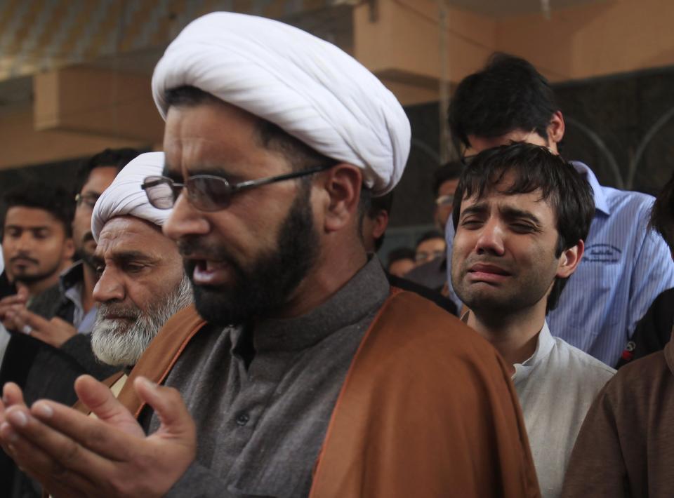 Man mourns the death of his relative, who was killed in Friday's explosion at a Shi'ite mosque, during funeral prayers in Peshawar