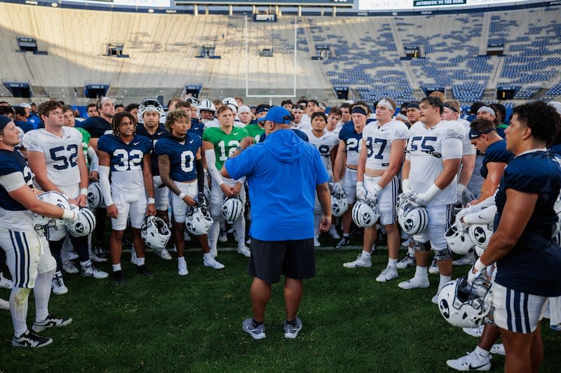 BYU players huddle around head coach Kalani Sitake after a scrimmage at LaVell Edwards Stadium on Aug. 17, 2024. | Jaren Wilkey, BYU Photo