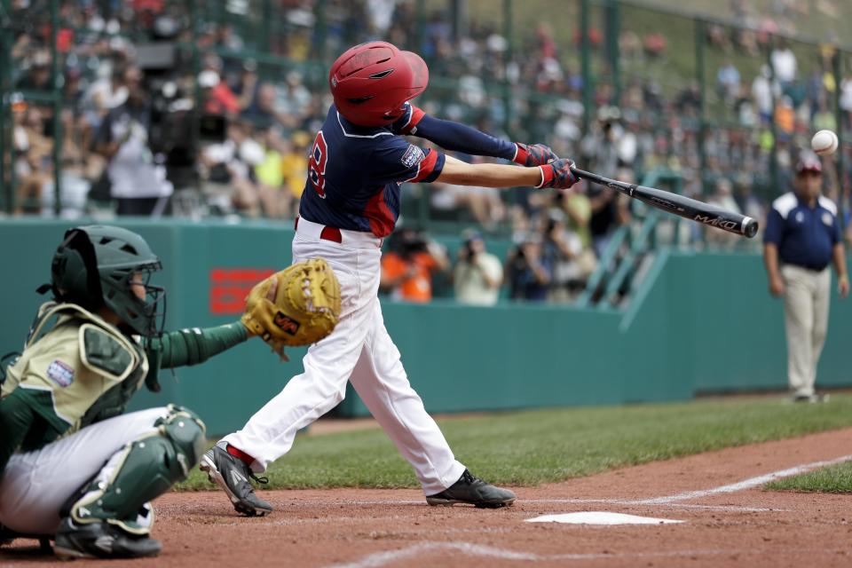 Endwell, N.Y.'s Conner Rush, center, drives in a run with a single off South Korea's Junho Jeong during the fourth inning of the Little League World Series Championship baseball game, Sunday, Aug. 28, 2016, in South Williamsport, Pa. (AP Photo/Matt Slocum)