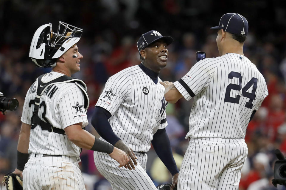 American League pitcher Aroldis Chapman, of the New York Yankees, jokes with teammate Gary Sanchez (24), of the New York Yankees, and James McCann, left, of the Chicago White Sox, after the American League defeated by National League 4-3 in the MLB baseball All-Star Game, Tuesday, July 9, 2019, in Cleveland. (AP Photo/John Minchillo)