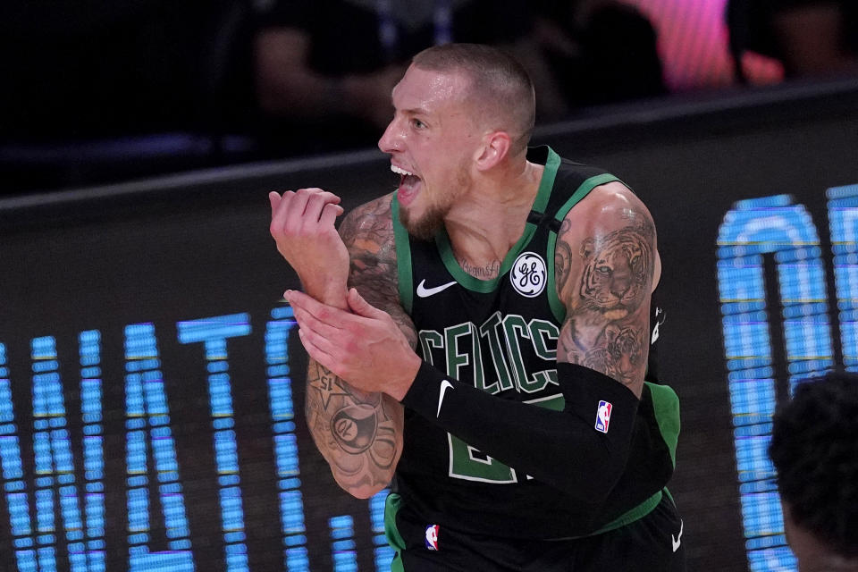 Boston Celtics' Daniel Theis reacts after going up for a shot against Toronto Raptors' Pascal Siakam during the first half of an NBA conference semifinal playoff basketball game Friday, Sept. 11, 2020, in Lake Buena Vista, Fla. (AP Photo/Mark J. Terrill)