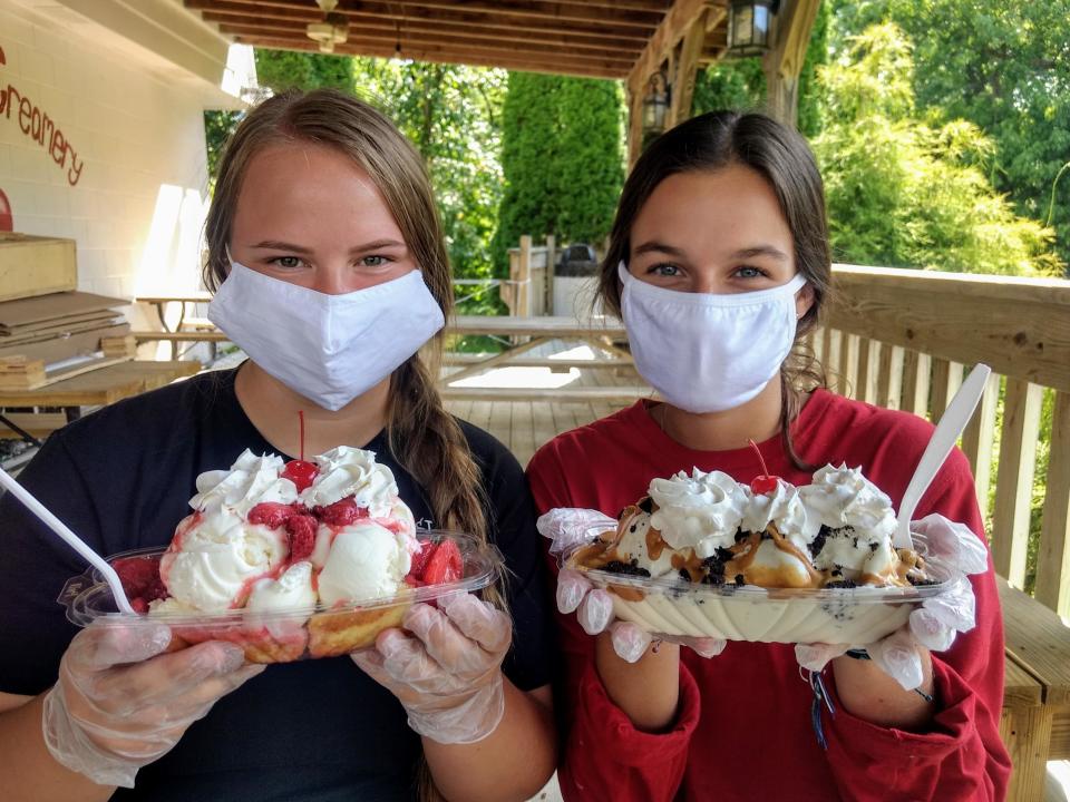Workers Grace Flowers (left) with a Strawberry Cassata Cake Sundae and Erin Steiner with a Trail Buster sundae at Cherry Street Creamery in Canal Fulton.