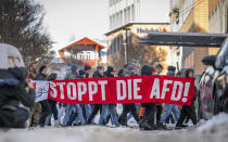 Participants walk with a banner that reads: "Stop the AfD!", in Erfurt, Germany, Saturday Jan. 20, 2024, tas part of nationwide demonstrations against right-wing extremism. (Jacob Schroeter/dpa via AP)