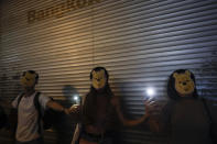 Protesters wear Winnie the Pooh masks during a protest in Hong Kong, Friday, Oct. 18, 2019. Hong Kong pro-democracy protesters are donning cartoon/superhero masks as they formed a human chain across the semiautonomous Chinese city, in defiance of a government ban on face coverings. (AP Photo/Mark Schiefelbein)