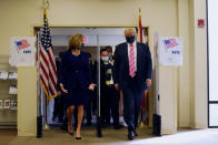 President Donald Trump walks with Wendy Sartory Link, Supervisor of Elections Palm Beach County, after casting his ballot for the presidential election, Saturday, Oct. 24, 2020, in West Palm Beach, Fla. (AP Photo/Evan Vucci)