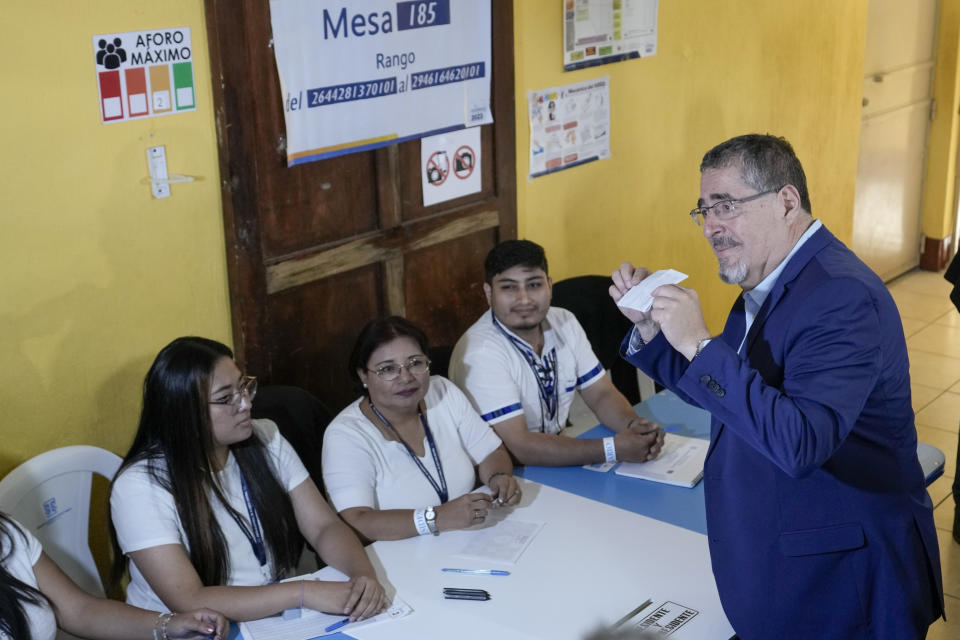 Bernardo Arevalo, presidential candidate with the Semilla Movement, shows his ballot in the run-off presidential election in Guatemala City, Sunday, Aug. 20, 2023. (AP Photo/Moises Castillo)