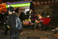 This photo taken and released by Hong Kong newspaper The South China Morning Post (SCMP) on February 9, 2016 shows rioters climbing on top a taxi