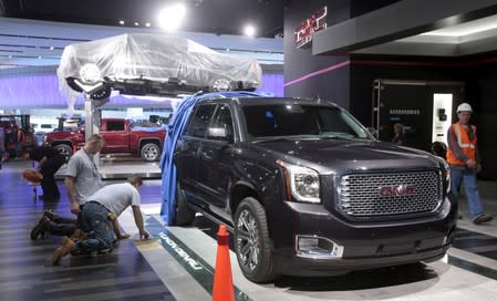 FILE PHOTO: A GMC 2016 Yukon Denali pickup truck is displayed on the show floor as carpenters work on the GMC display stand before press days of the North American International Auto Show at Cobo Center in Detroit