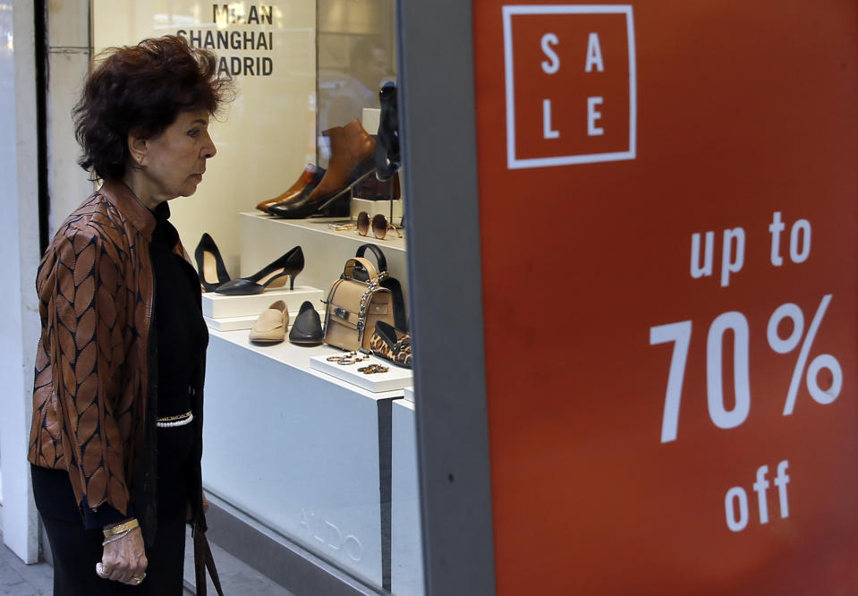 A woman looks at a shop window displaying shoes, in Beirut, Lebanon, Wednesday, Nov. 20, 2019. Lebanon’s worsening financial crisis has thrown businesses and households into disarray. Banks are severely limiting withdrawals of hard currency, and Lebanese say they don’t know how they’ll pay everything from tuitions to insurance and loans all made in dollars. Politicians are paralyzed, struggling to form a new government in the face of tens of thousands of protesters in the streets for the past month demanding the entire leadership go. (AP Photo/Bilal Hussein)