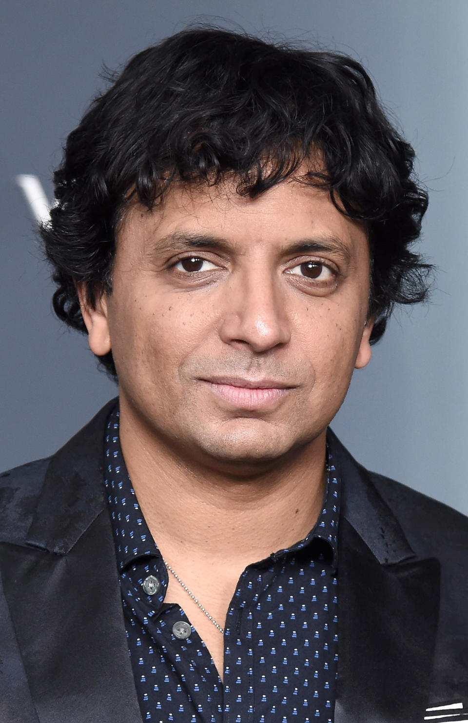 M Night Shyamalan posing at an event