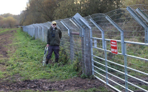 Steve Burke stood in front of Wingham Fisheries otter fence - Credit: Steve Burke/BNPS 