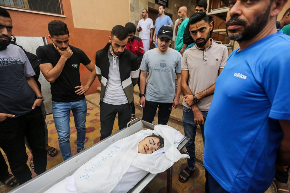 People mourn a child as they collect the bodies of Palestinians killed in Israeli air raids on November 8, 2023 in Khan Yunis, Gaza. (Photo by Ahmad Hasaballah/Getty Images)