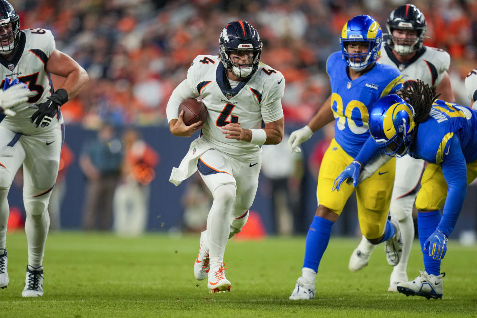 Denver Broncos quarterback Jarrett Stidham runs against the Los Angeles Rams during the first half of an NFL preseason football game Saturday, Aug. 26, 2023, in Denver. (AP Photo/Jack Dempsey)