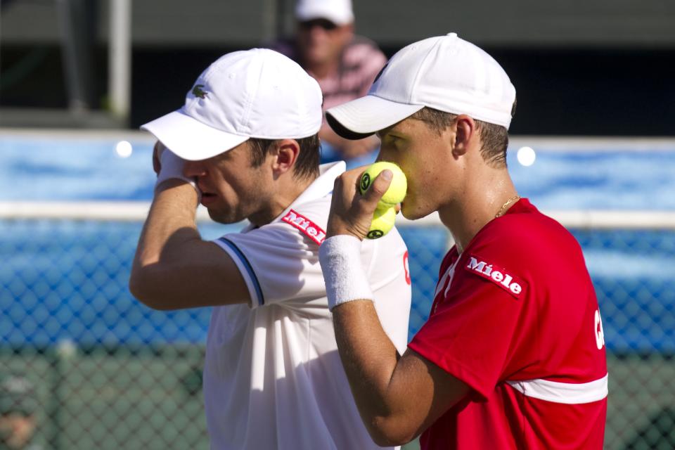 Canadian tennis player Daniel Nestor (L) and Vasek Pospisil (R) prepar a strategy against Israeli tennis team players Jonathan Erlich and Andy Ram of Israel tennis team during their Davis Cup world group doubles playoff tennis match in Ramat Hasharon near Tel Aviv on September 17, 2011. AFP PHOTO/JACK GUEZ (Photo credit should read JACK GUEZ/AFP/Getty Images)