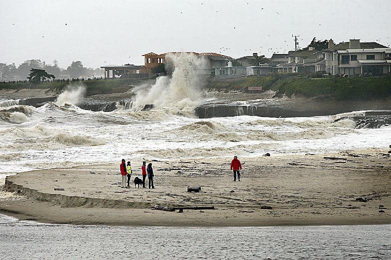 Roiling storm waves pound the rock ledge of Santa Maria Cliffs a few hours before high tide, Sunday, Jan. 8, 2017. Residents and authorities cleared storm drains and stacked sand bags, preparing for the system expected to reach full force late Sunday and early Monday. (Dan Coyro/The Santa Cruz Sentinel via AP)