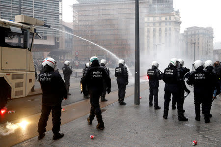 Police officers use a water cannon during a protest against Marrakesh Migration Pact in Brussels, Belgium December 16, 2018. REUTERS/Francois Lenoir