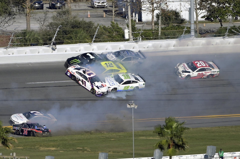 Kurt Busch (1), Denny Hamlin (11), Aric Almirola (10), Ryan Blaney (12) and Kevin Harvick (4) are involved in a multi-car collision between Turns 3 and 4 during the NASCAR Daytona Clash auto race at Daytona International Speedway, Sunday, Feb. 9, 2020, in Daytona Beach, Fla. (AP Photo/Phelan M. Ebenhack)