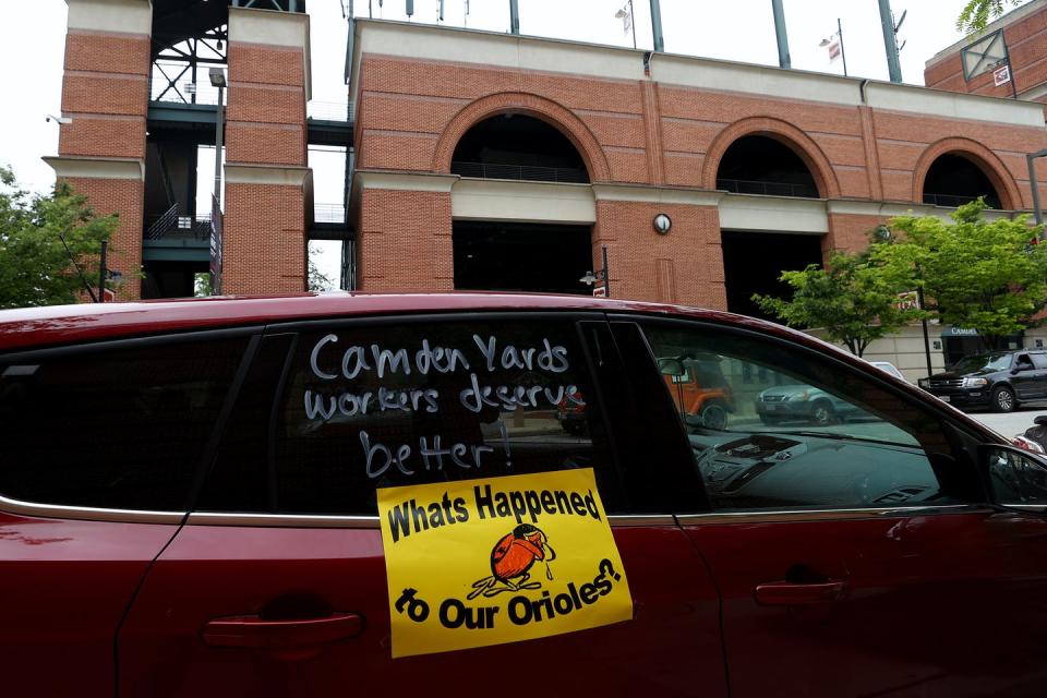 <span class="caption">Outside Camden Yards in Baltimore, Maryland, concession workers call for the Baltimore Orioles baseball team to pay the workers unemployment insurance benefits. The start of the baseball season has been delayed due to the COVID-19 pandemic.</span> <span class="attribution"><a class="link " href="https://www.gettyimages.com/detail/news-photo/cars-of-concession-workers-line-up-outside-of-camden-yards-news-photo/1224888517?adppopup=true" rel="nofollow noopener" target="_blank" data-ylk="slk:Getty Images / Rob Carr;elm:context_link;itc:0;sec:content-canvas">Getty Images / Rob Carr</a></span>