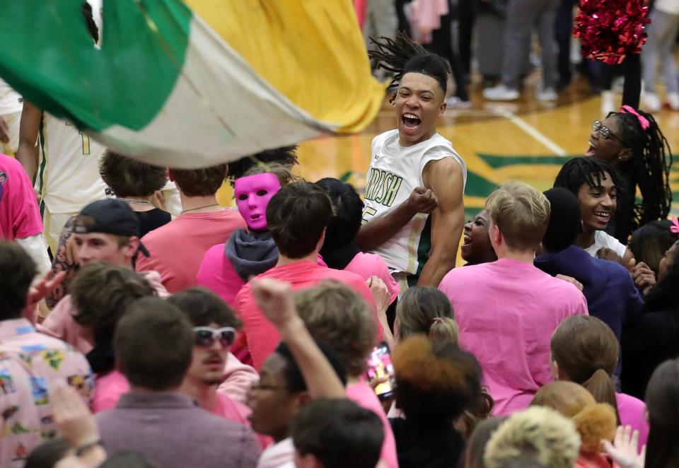 STVM forward Rayshawn Hamilton, top, celebrates with the student section after beating Walsh Jesuit at LeBron James Arena on Feb. 6 in Akron.