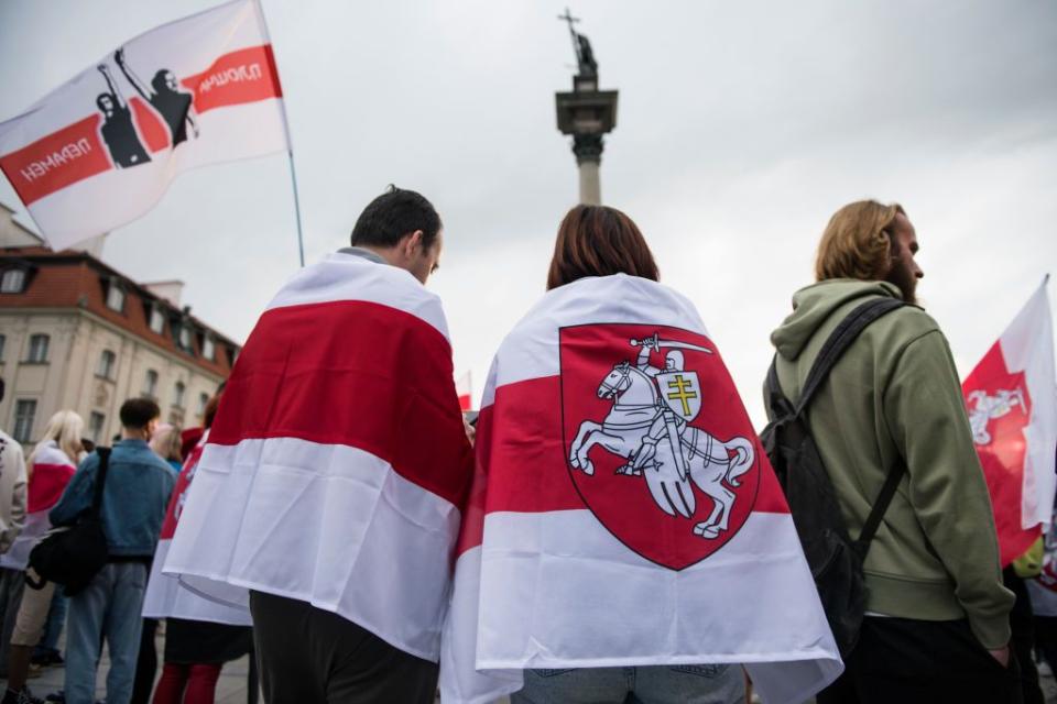 During the march in Warsaw on Aug. 9, Belarusian dissidents wave banned white-and-red flags, the symbol of free Belarus. (Attila Husejnow/SOPA Images/LightRocket via Getty Images)