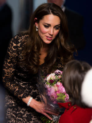 <p>Kate accepts flowers from a child at the UK premiere of 'War Horse'.</p>