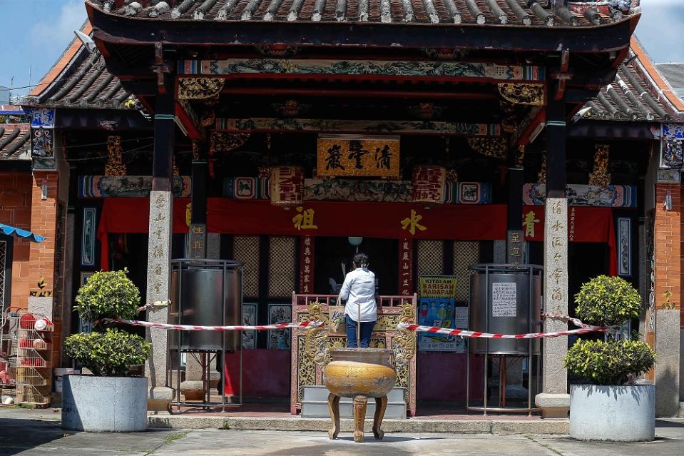 A woman is seen offering prayers at the Snake Temple in Bayan Baru, Penang October 15, 2021. ― Picture by Sayuti Zainudin