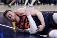 New York Knicks center Isaiah Hartenstein reacts after getting injured during the first half of Game 4 against the Indiana Pacers in an NBA basketball second-round playoff series, Sunday, May 12, 2024, in Indianapolis. (AP Photo/Michael Conroy)