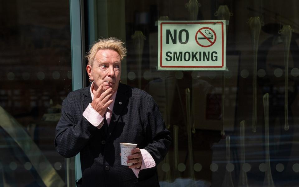 John Lydon, aka Johnny Rotten, smokes outside the Rolls Building at the High Court, London - PA