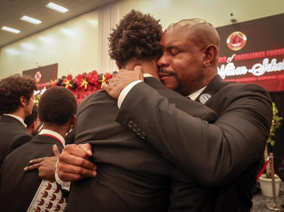 Norland graduate Triston Wilson, left, who received his signing pin from his father, Paul V. Wilson Jr., receives a hug of pride and joy during the 31st consecutive year of the Wilson Scholars Academic Signing Ceremony of the 5000 Role Models of Excellence Project connected Wilson Scholars from public high schools in Miami to full scholarship support to prestigious colleges and universities during its ceremony held at the Miami Dade College-North Campus SOJ Multipurpose Room on Sunday, June 9, 2024 in Miami, Florida.