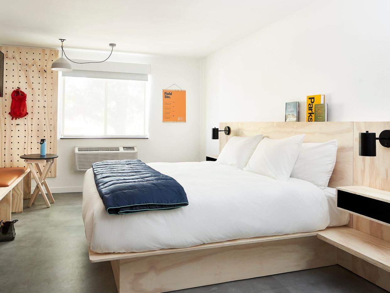 Inside a Field Station hotel room with a bed, furniture.