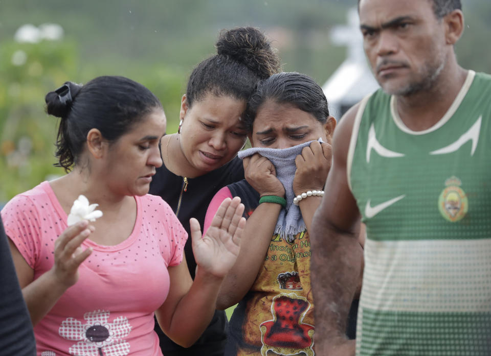 Relatives of 25-year-old William de Souza, an inmate who was killed in the recent prison riots, grieve during his burial service, in Manaus, Brazil, Thursday, May 30, 2019. Families were burying victims of several prison riots in which dozens of inmates died in the northern Brazilian state of Amazonas, as authorities confirmed they had received warnings of an “imminent confrontation” days before the attacks begun. (AP Photo/Andre Penner)