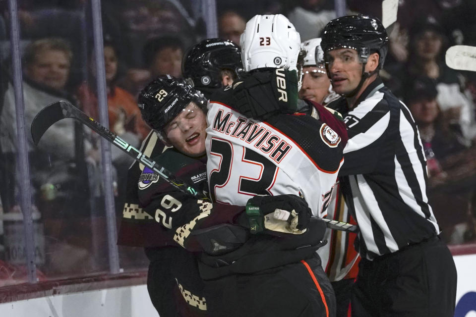 Arizona Coyotes' Barrett Hayton (29) holds back Anaheim Ducks' Mason McTavish (23) during a skirmish in the second period of an NHL hockey game Saturday, Oct. 21, 2023, in Tempe, Ariz. (AP Photo/Darryl Webb)