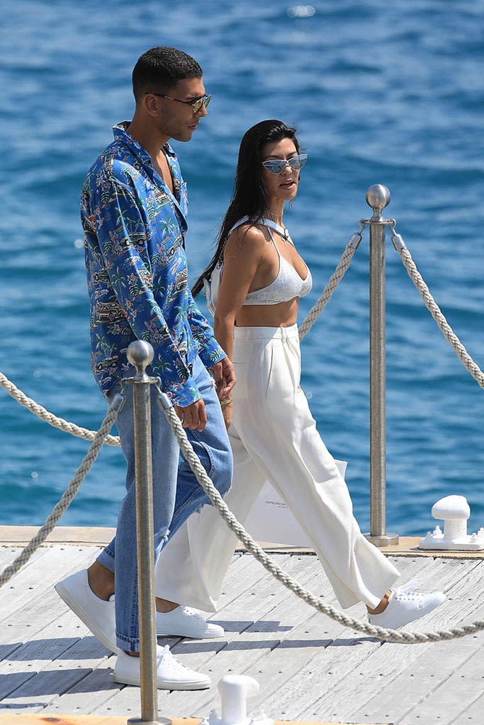 <p>Kourtney and Younes took a romantic stroll on the boardwalk. The reality star dressed all in white, capping off her look with a sparkly white bikini top. Basically, she never put a shirt on the entire time she was in France. (Photo: Robino Salvatore/GC Images) </p>