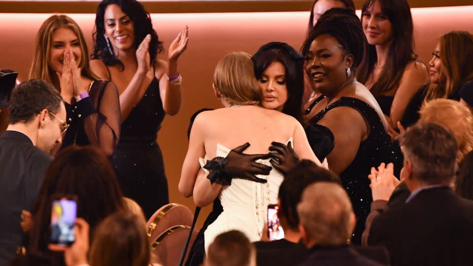 The pop superstar embraces Lana Del Rey at the Grammy Awards on Sunday after winning album of the year for "Midnights." - Valerie Macon/AFP/Getty Images