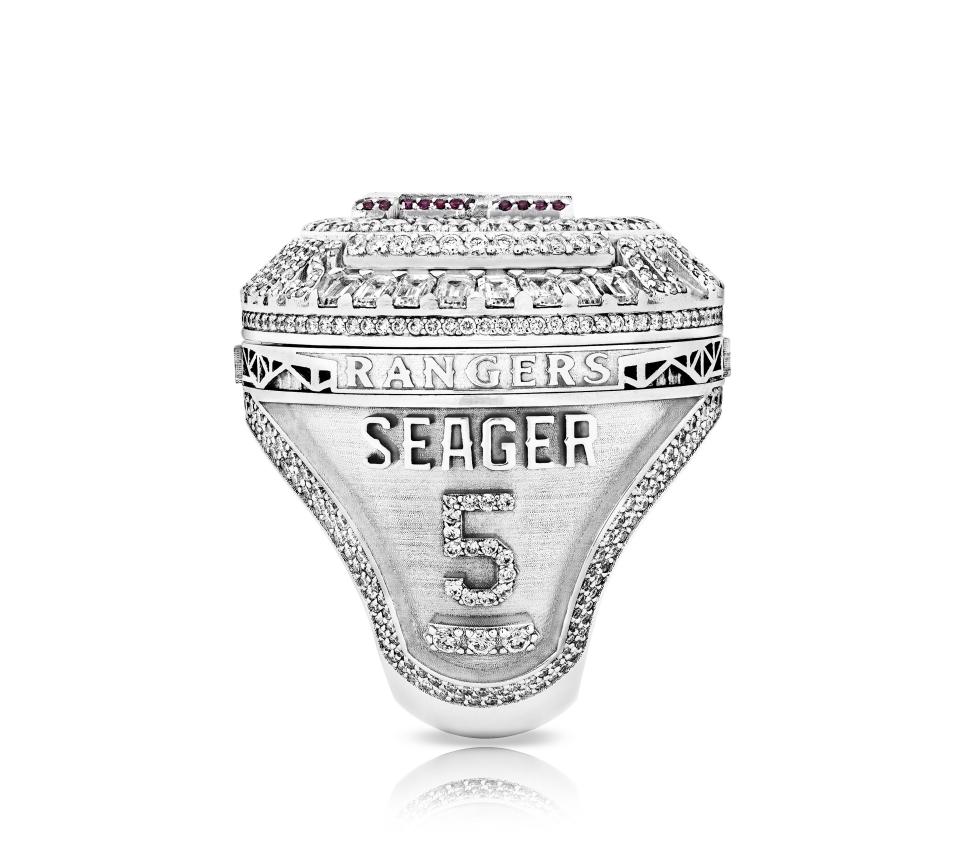 The side of the Texas Rangers World Series ring features the player's name and number and three diamonds to signify the team's foundational values: Compete with passion, be a good teammate, and dominate the fundamentals.