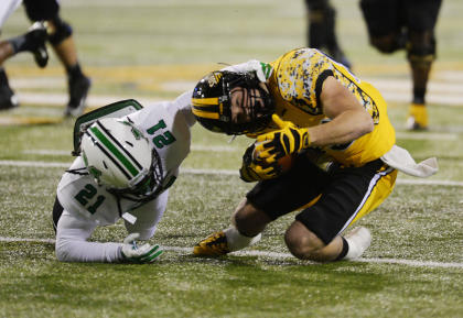 Southern Mississippi's Cooper Harrington (83) gets tackled by Marshall safety Tiquan Lang (21). (AP Photo/Steve Coleman)