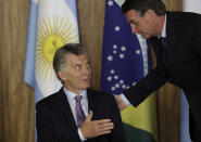 Brazil's President Jair Bolsonaro, right, talks with Argentina's President Mauricio Macri during a meeting at Planalto presidential palace in Brasilia, Brazil, Wednesday, Jan. 16, 2019. Macri is a one-day visit to Brazil. (AP Photo/Eraldo Peres)