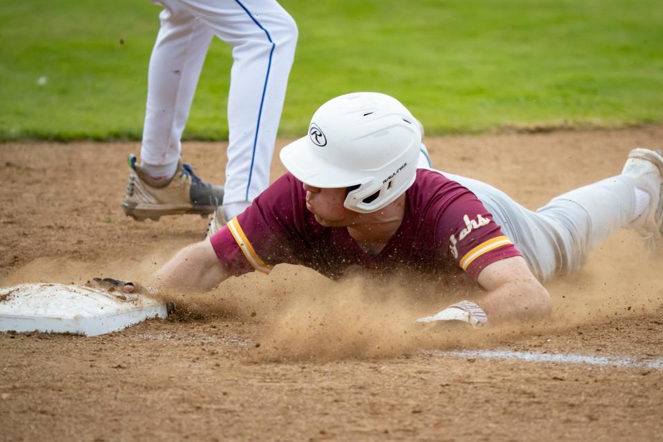 Junction City’s Connor Koon slides safely back to first as the Cottage Grove Lions host Junction City Friday, April 12, 2024, in Cottage Grove, Ore.