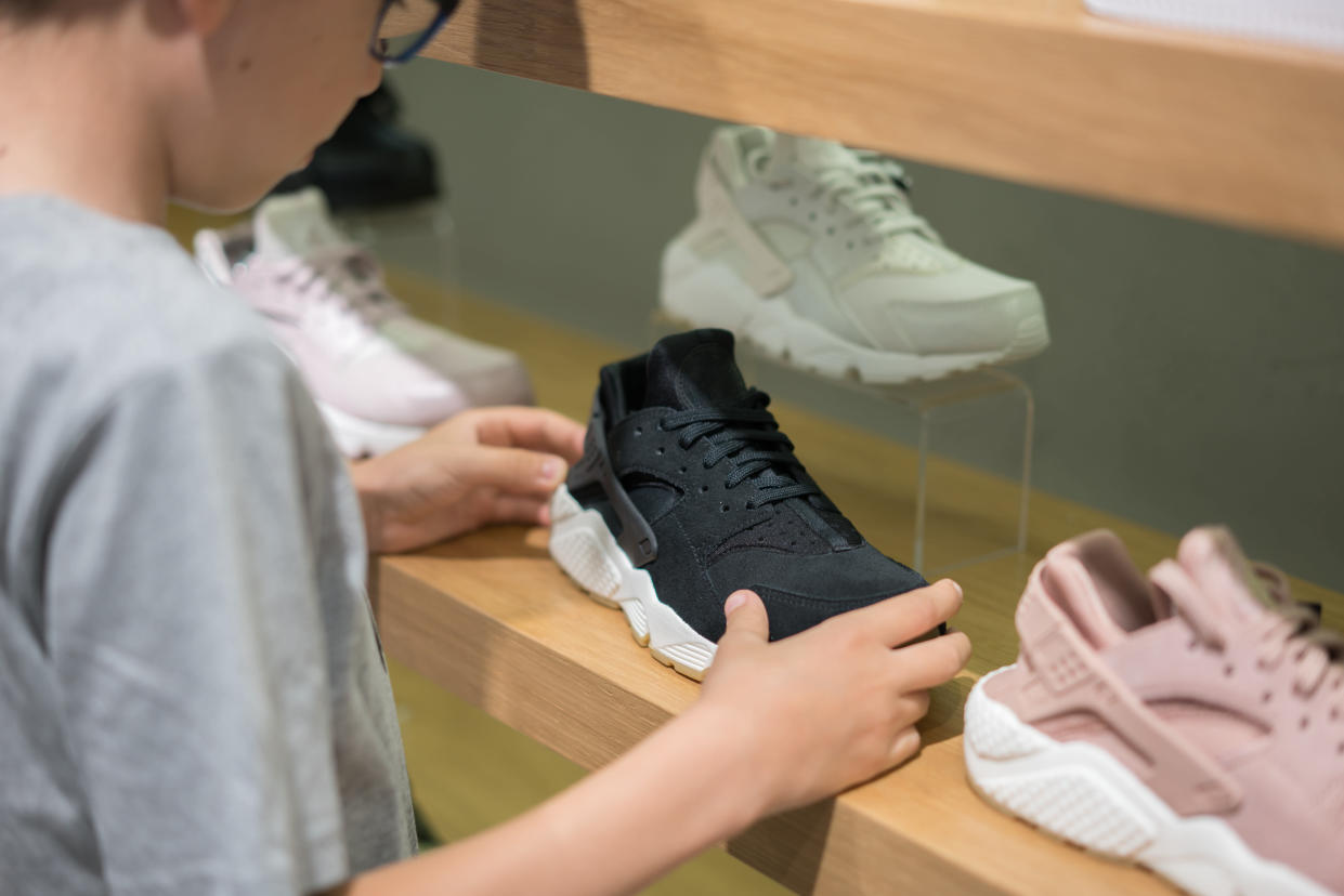 Boy Shopping for New Shoes in Fashion Store